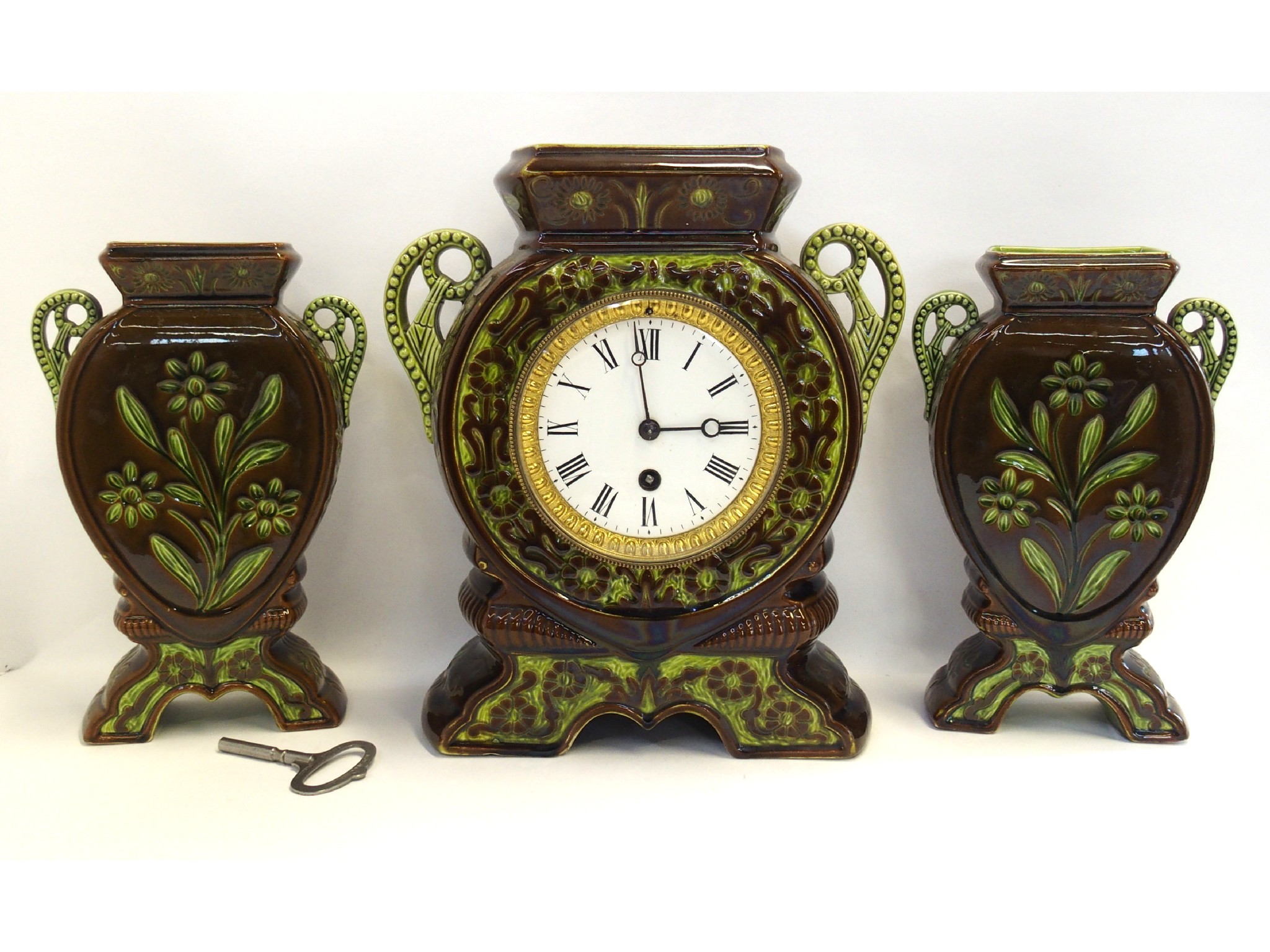 Appraisal: Pottery clock garniture marked Lear comprising clock and pair of