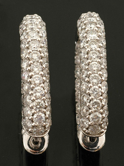 Appraisal: A pair of diamond hoop earrings The oval hoops grain