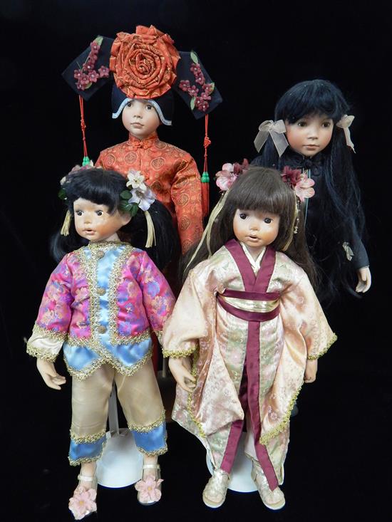 Appraisal: DOLLS Four unmarked new Oriental dolls beautifully dressed with stands