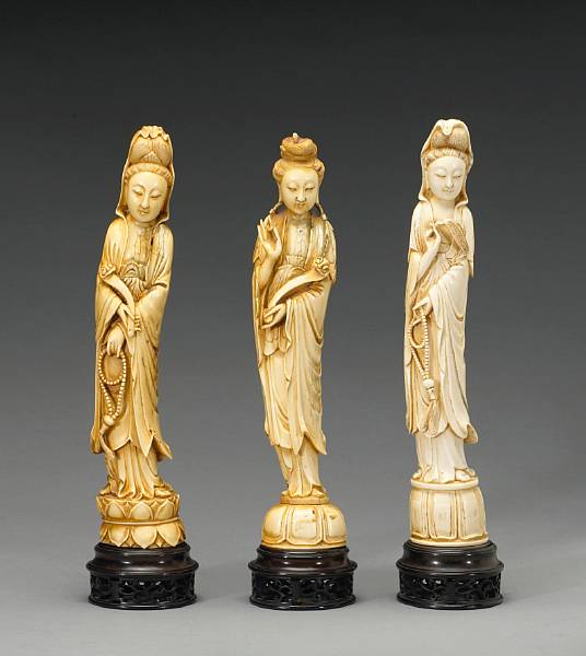 Appraisal: A group of three tinted ivory figures of Guanyin First