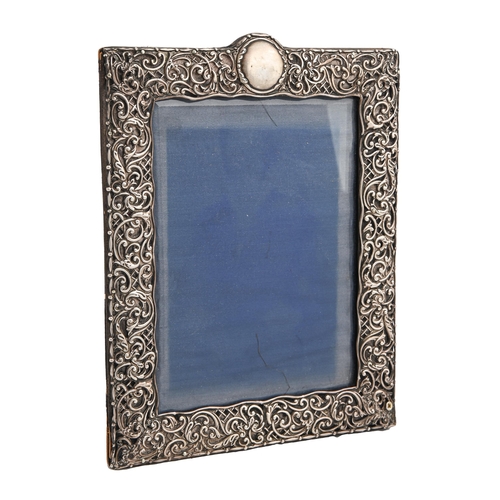 Appraisal: An Edwardian silver photograph frame the die stamped mount with