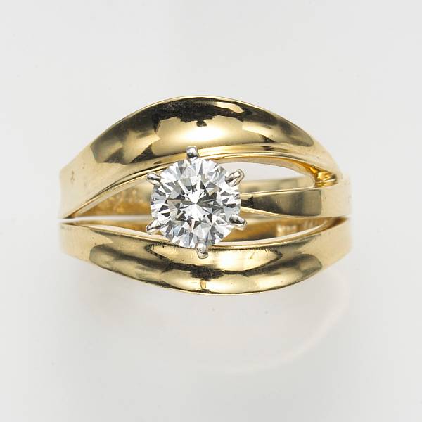 Appraisal: A round brilliant-cut diamond and fourteen karat gold wedding set