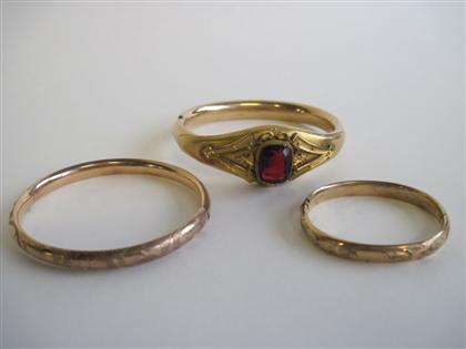 Appraisal: Collection of three gold fill banglesComprising a bangle with a