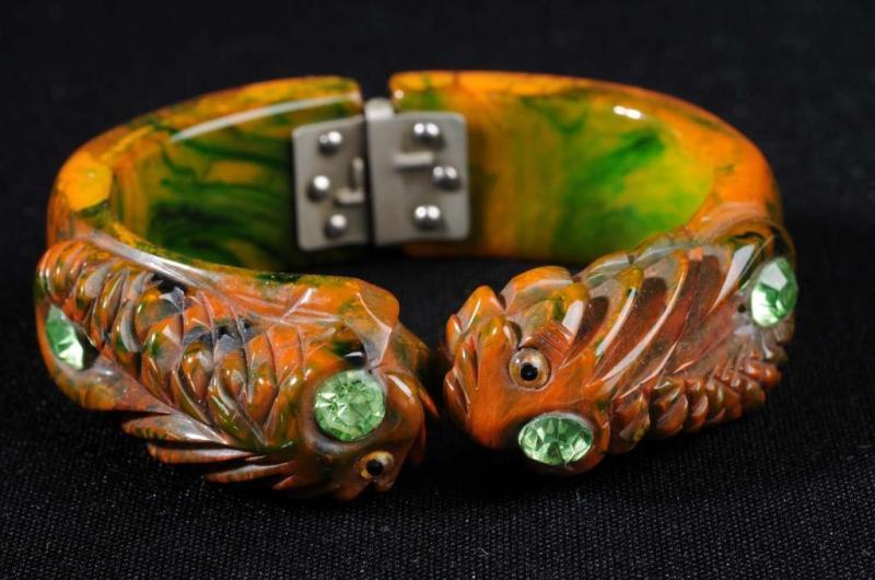 Appraisal: Bakelite Fish Hinged Bracelet Description Deeply carved green and butterscotch