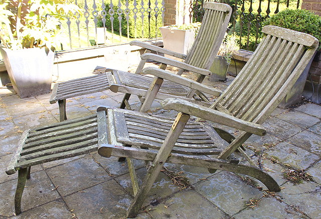 Appraisal: A PAIR OF TEAK STEAMER ARMCHAIRS with labels for David