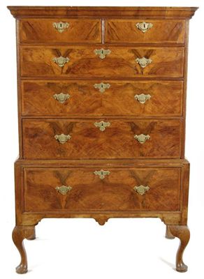 Appraisal: A walnut chest on stand with a moulded cornice above