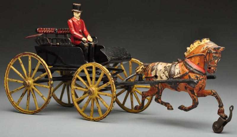 Appraisal: Cast Iron -Seat Surrey Horse-Drawn Toy Description American Made by