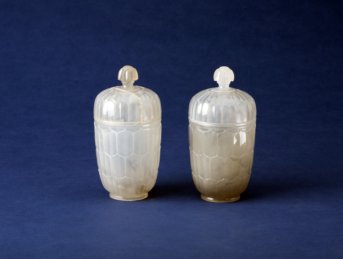 Appraisal: PAIR OF WHITE CARVED JADE COVERED CUPS WITH HONEYCOMB MOTIF