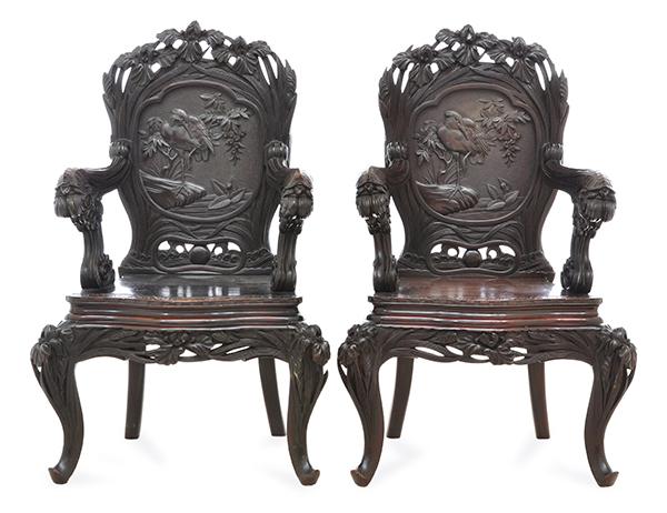 Appraisal: A PAIR OF CHINESE ROSEWOOD ARMCHAIRSCARVED WITH FOLIAGE STORKS AND