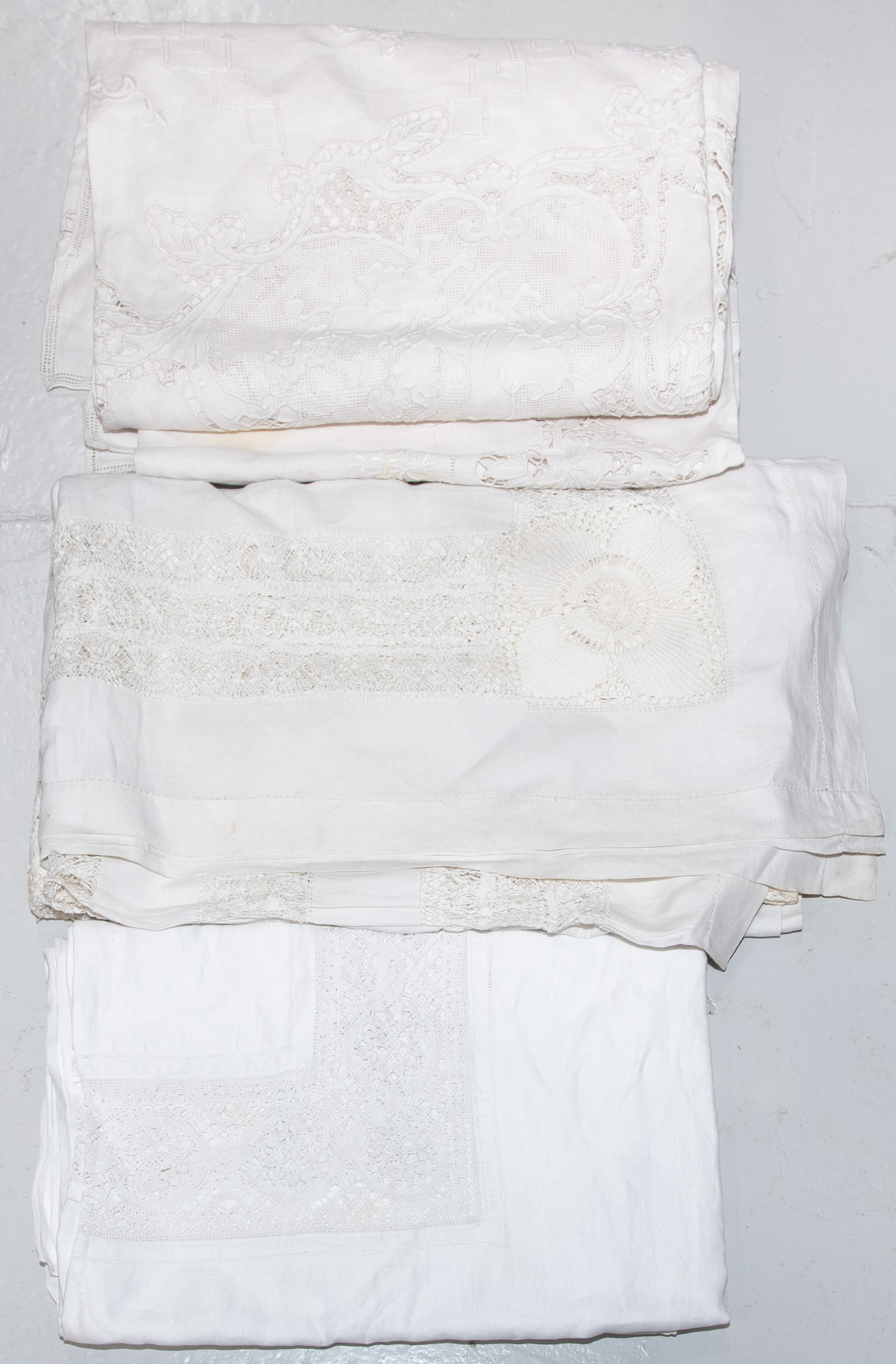 Appraisal: ASSORTMENT OF VINTAGE TABLE LINENS Comprising three vintage partial-lace tablecloths