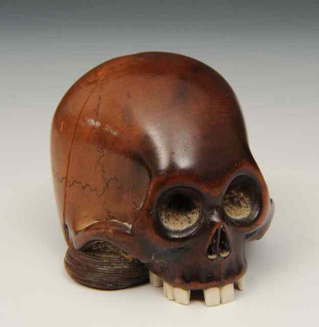 Appraisal: A JAPANESE CARVED WOOD NETSUKE Toma Hisa in the form