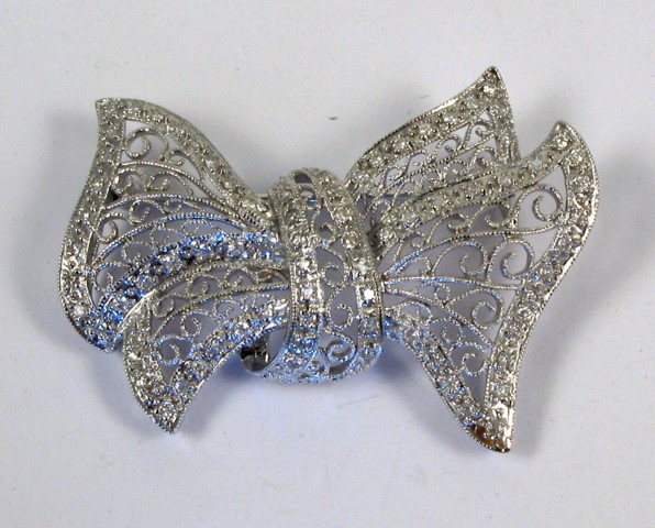 Appraisal: DIAMOND AND FOURTEEN KARAT GOLD BROOCH The pierced white gold