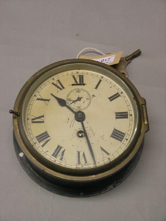 Appraisal: A circular brass ship's timepiece the printed dial indistinctly dated