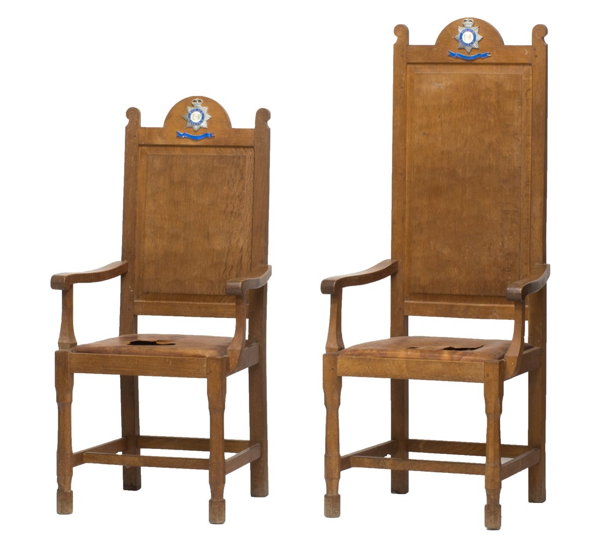 Appraisal: An oak ceremonial armchair with fielded panel and leather seat