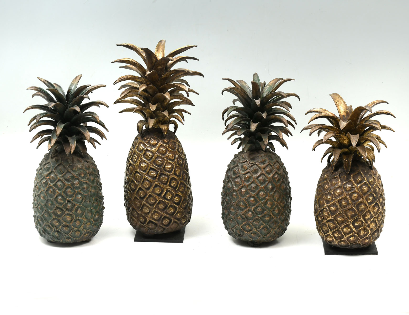 Appraisal: AFRICAN BRONZE PINEAPPLES bronze pineapples from the Ivory Coast made