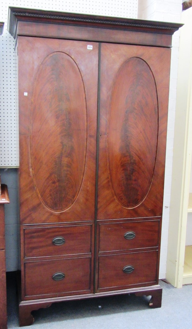 Appraisal: A George III mahogany hall cupboard the pair of doors