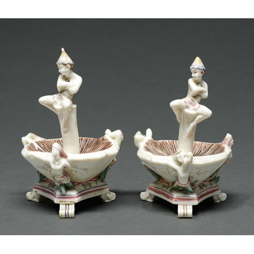 Appraisal: Two early Royal Worcester pixie-on-a-toadstool salt cellars supported by three