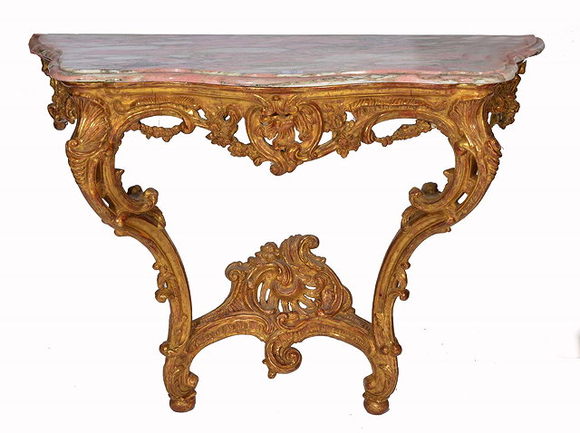 Appraisal: A FRENCH GILTWOOD SERPENTINE CONSOLE TABLE with variegated pink marble