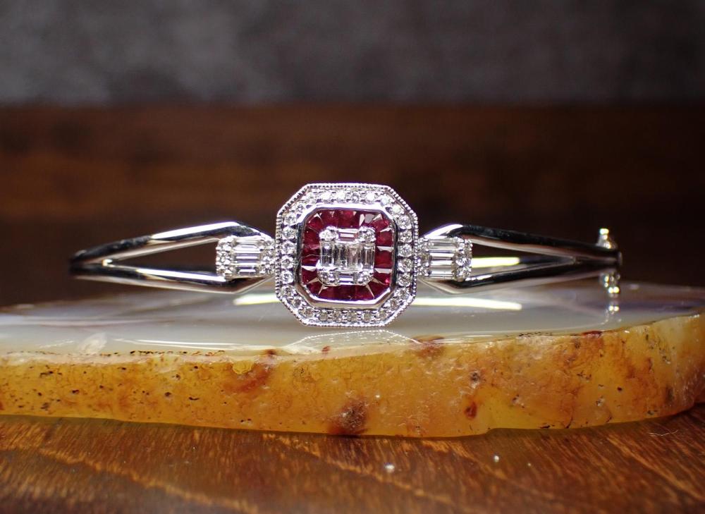 Appraisal: DIAMOND RUBY AND EIGHTEEN KARAT GOLD BANGLE The k white