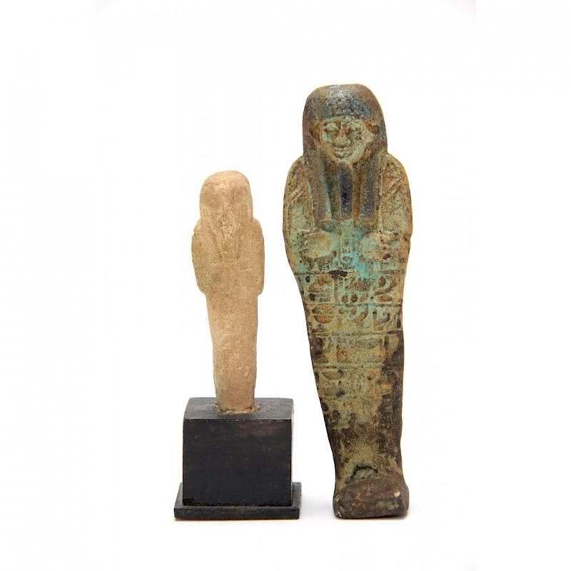 Appraisal: Two Egyptian Ushabtis the first of light green faience hieroglyphics