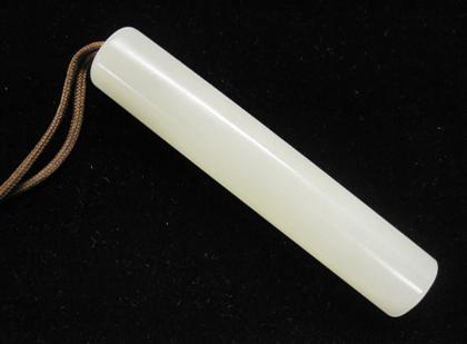 Appraisal: Chinese white jade cylindrical toggle The unadorned cylinder with one