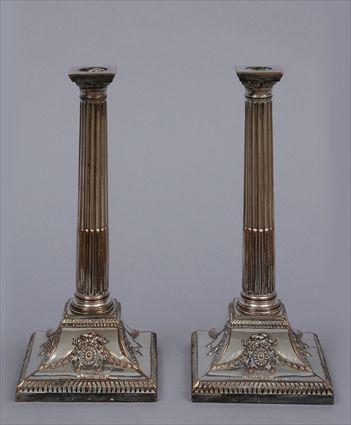 Appraisal: PAIR OF ENGLISH SILVER-PLATED COLUMN-FORM TABLE CANDLESTICKS Each stop-fluted stem