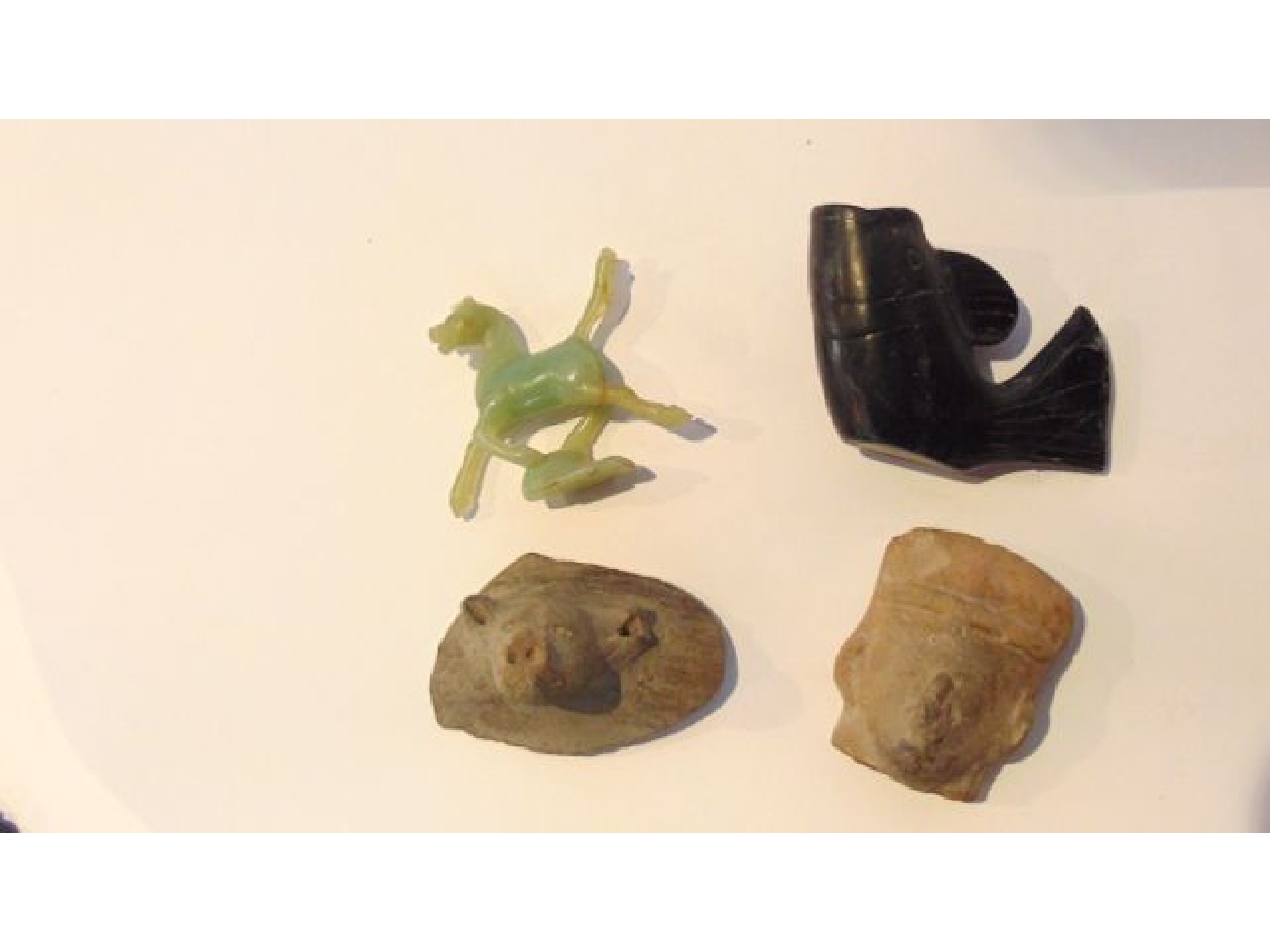 Appraisal: A pottery fragment with relief moulded grotesque animal head together