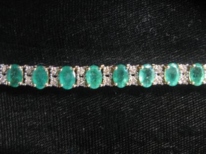 Appraisal: karat yellow gold emerald and diamond bracelet Twenty-six oval cut