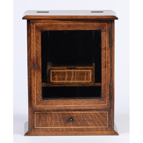 Appraisal: An Edwardian oak and inlaid smoker's cabinet with fitted interior