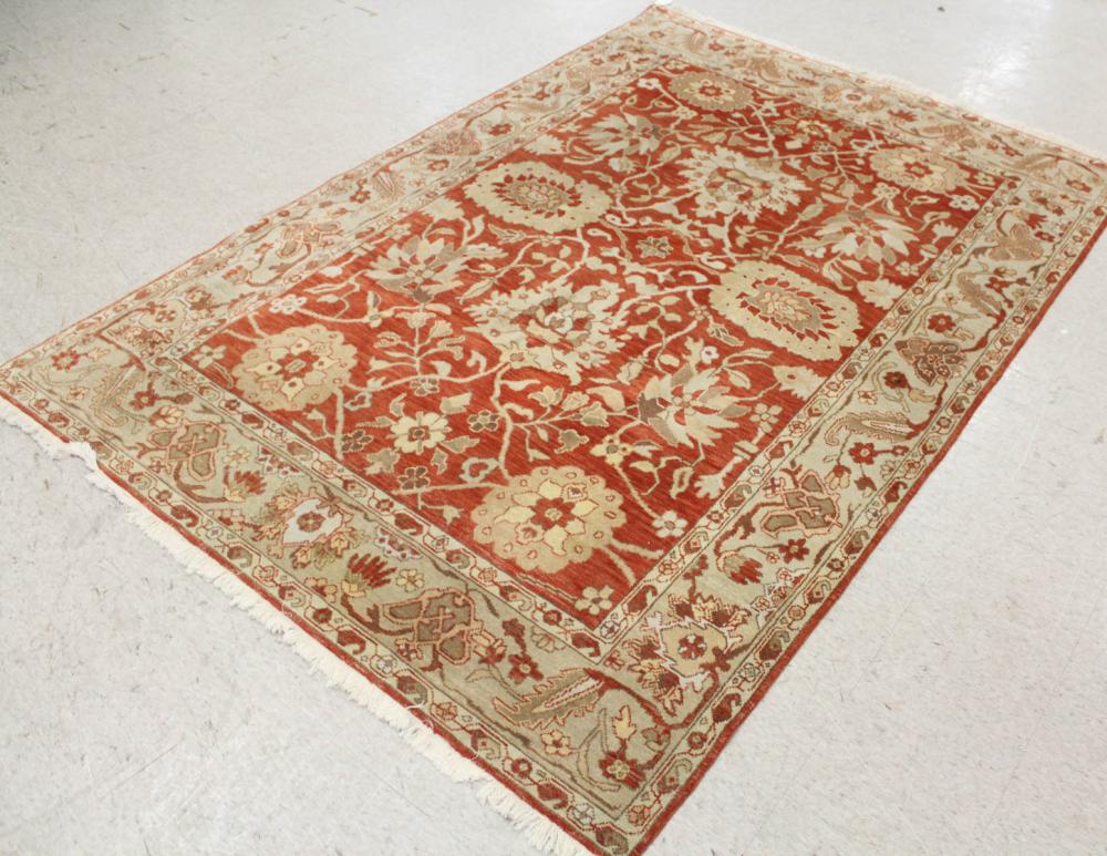 Appraisal: HAND KNOTTED ORIENTAL CARPET Indo-Persian stylized floral design on persimmon