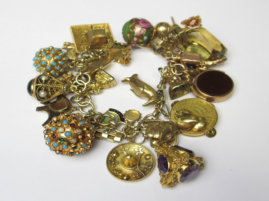 Appraisal: A nine carat gold charm bracelet with twenty two various