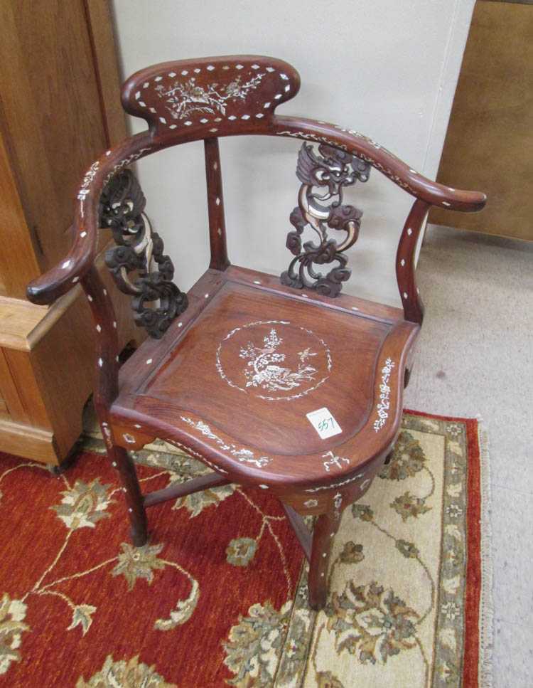 Appraisal: CHINESE MING STYLE CORNER ARMCHAIR of solid rosewood construction with