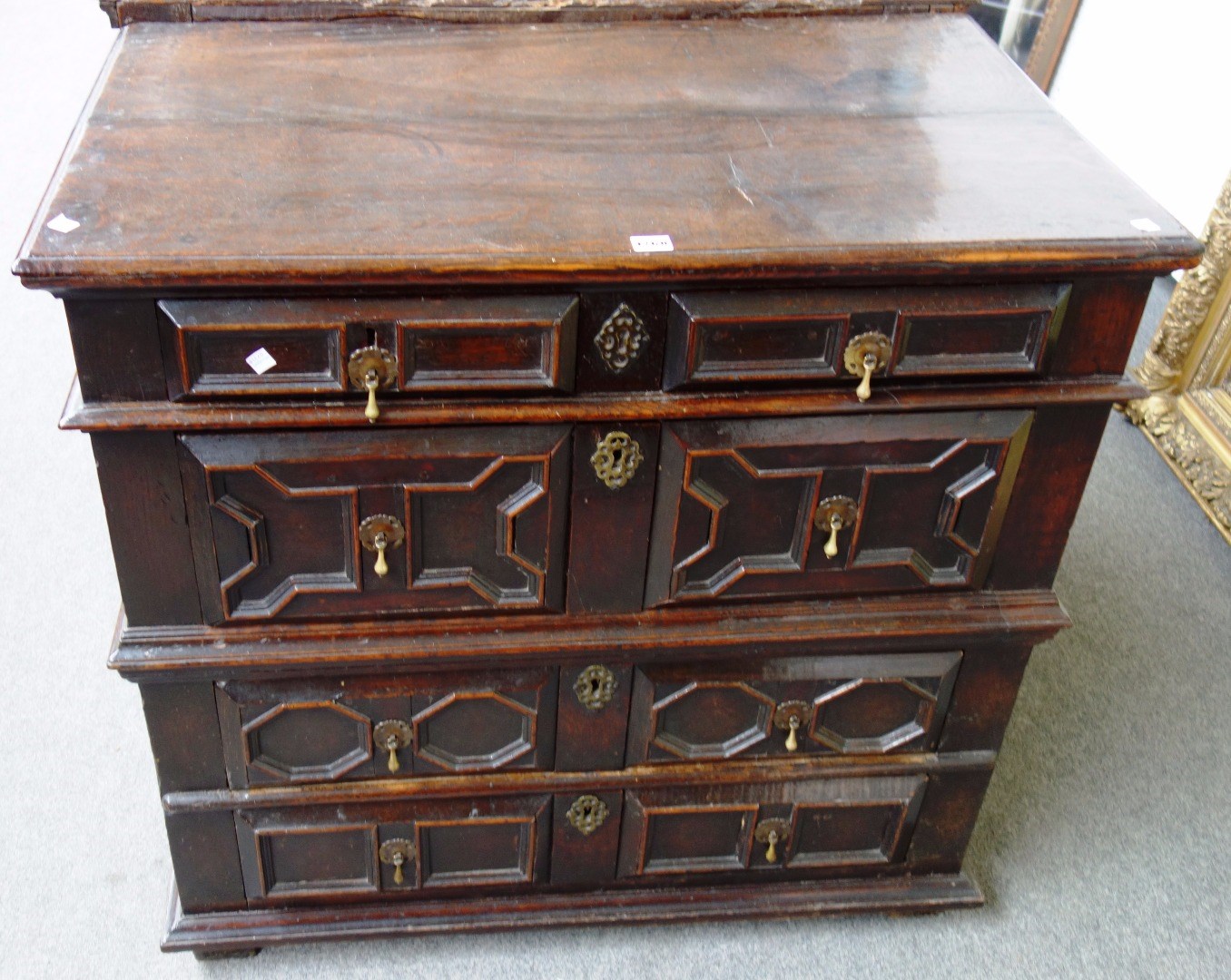 Appraisal: A th century oak chest of four graduated geometric moulded