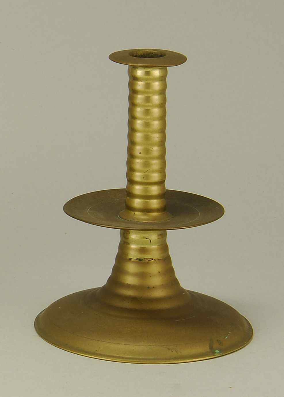 Appraisal: ANTIQUE SPUN BRASS CANDLESTICK WITH MID-DRIP PAN th CenturyProbably European