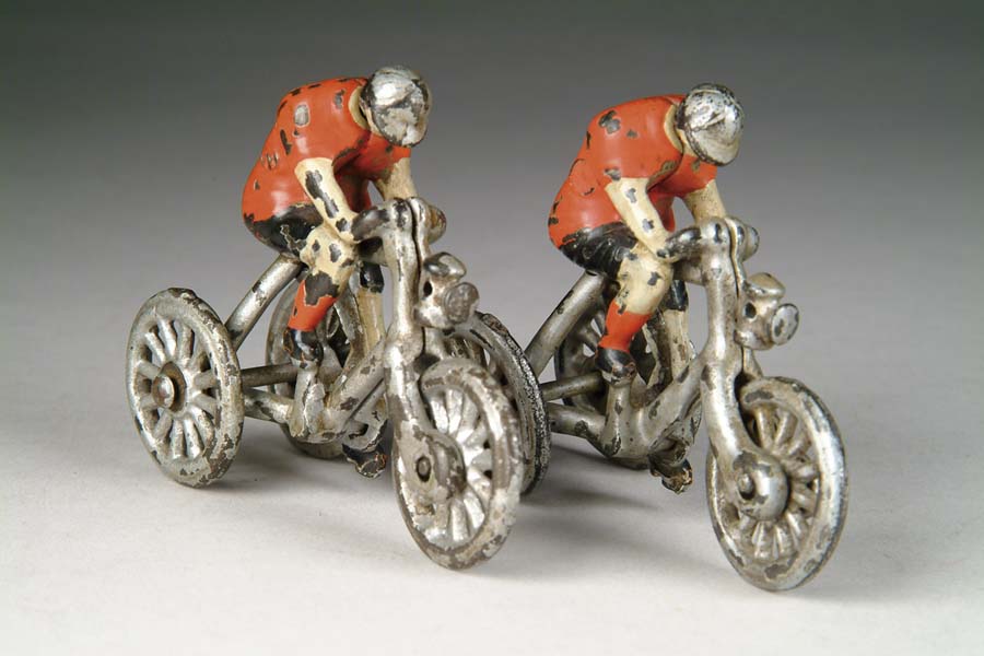 Appraisal: PAIR OF CAST IRON RIDERS ON BIKES Attributed to Ideal