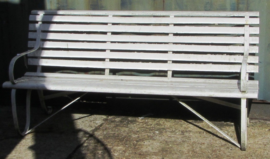 Appraisal: A white painted wrought iron and wooden slatted garden bench