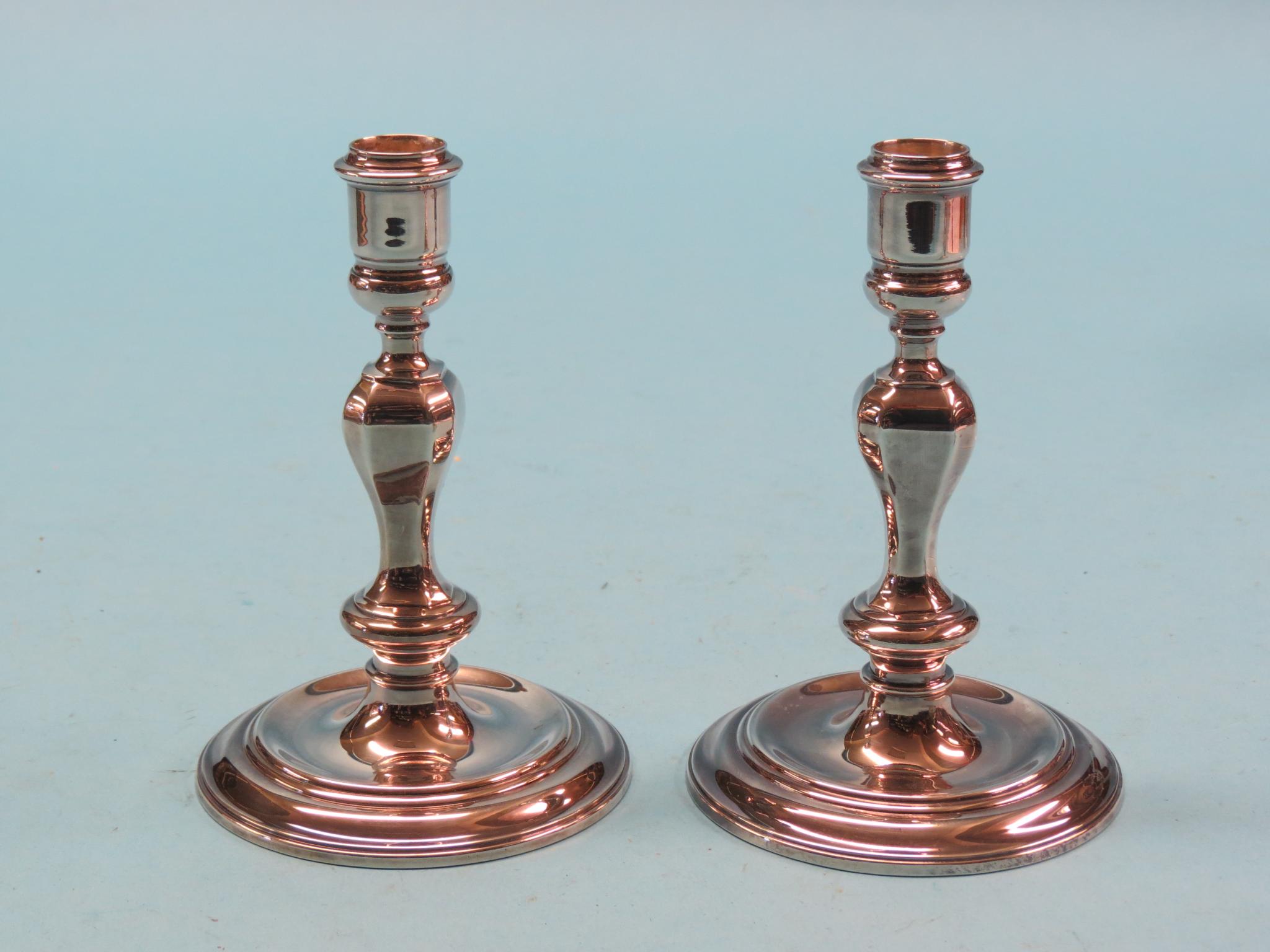 Appraisal: A pair of early Georgian-style silver candlesticks baluster stems and