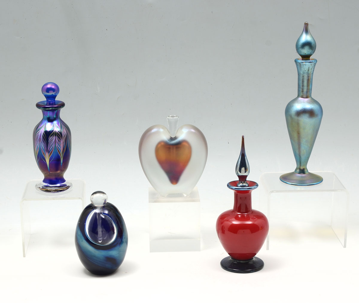 Appraisal: ART GLASS PERFUME BOTTLE COLLECTION Comprising blue iridescent bottle and