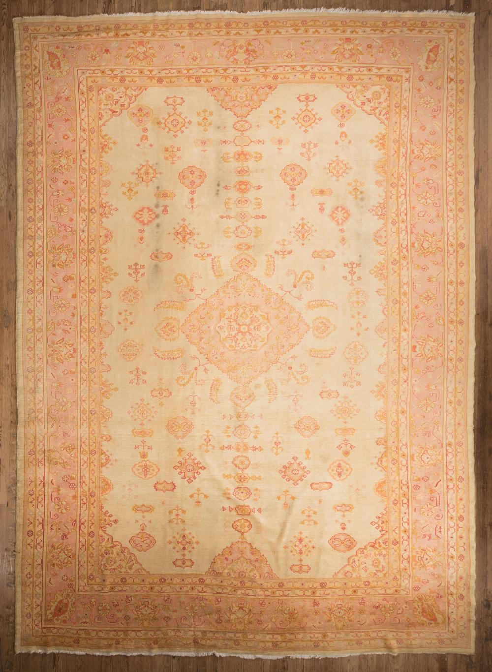 Appraisal: Oushak Carpet in pale yellow ground floral designs in pink