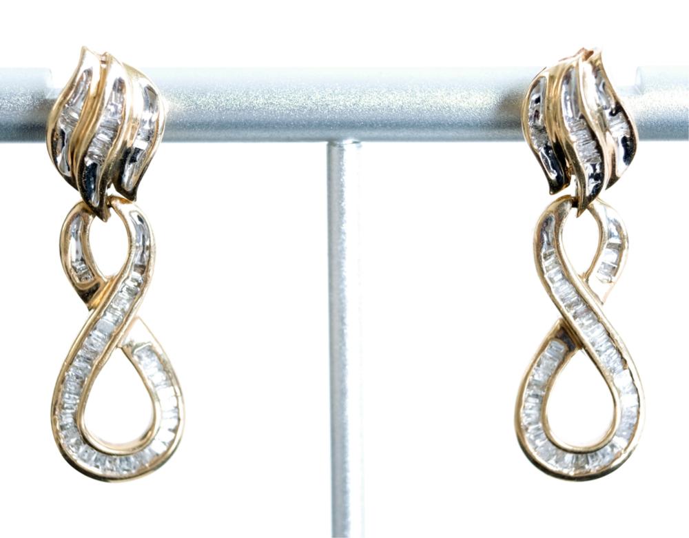 Appraisal: K YG FIGURE EIGHT STYLE DIAMOND EARRINGS k yellow gold