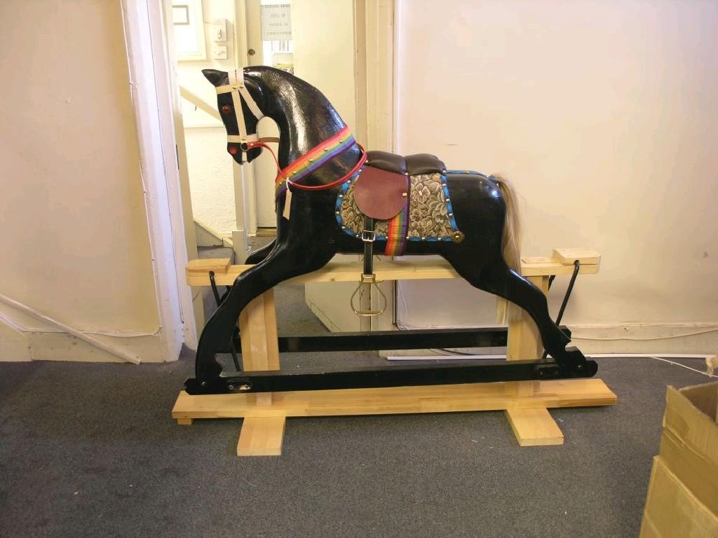 Appraisal: A modern carved wood rocking horse finished in black complete