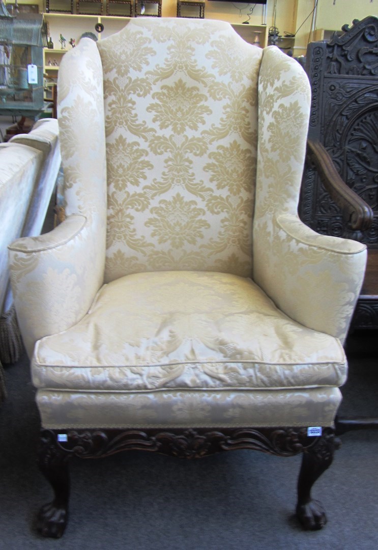 Appraisal: An early th century style high wingback armchair on carved