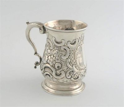 Appraisal: A George III baluster mug with later embossed decoration leaf