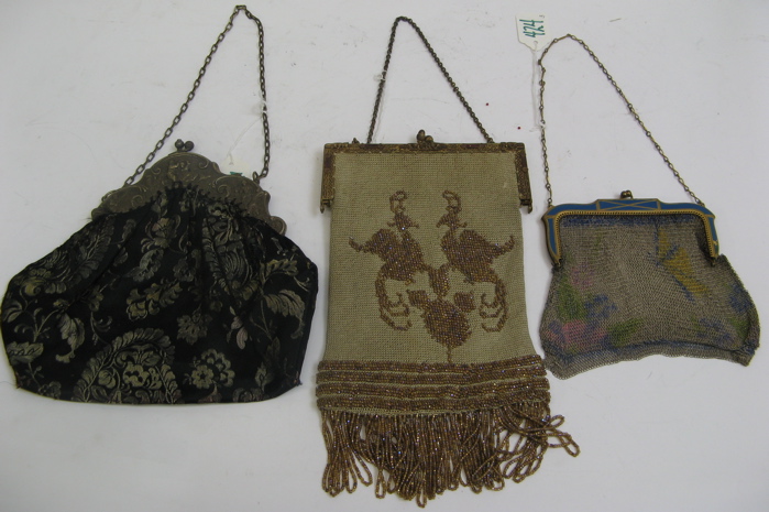 Appraisal: THREE LADY'S EVENING PURSES raised metal dancing figures on the