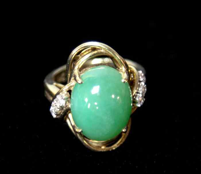 Appraisal: LADY'S JADEITE AND DIAMOND COCKTAIL RING the deep cabochon of