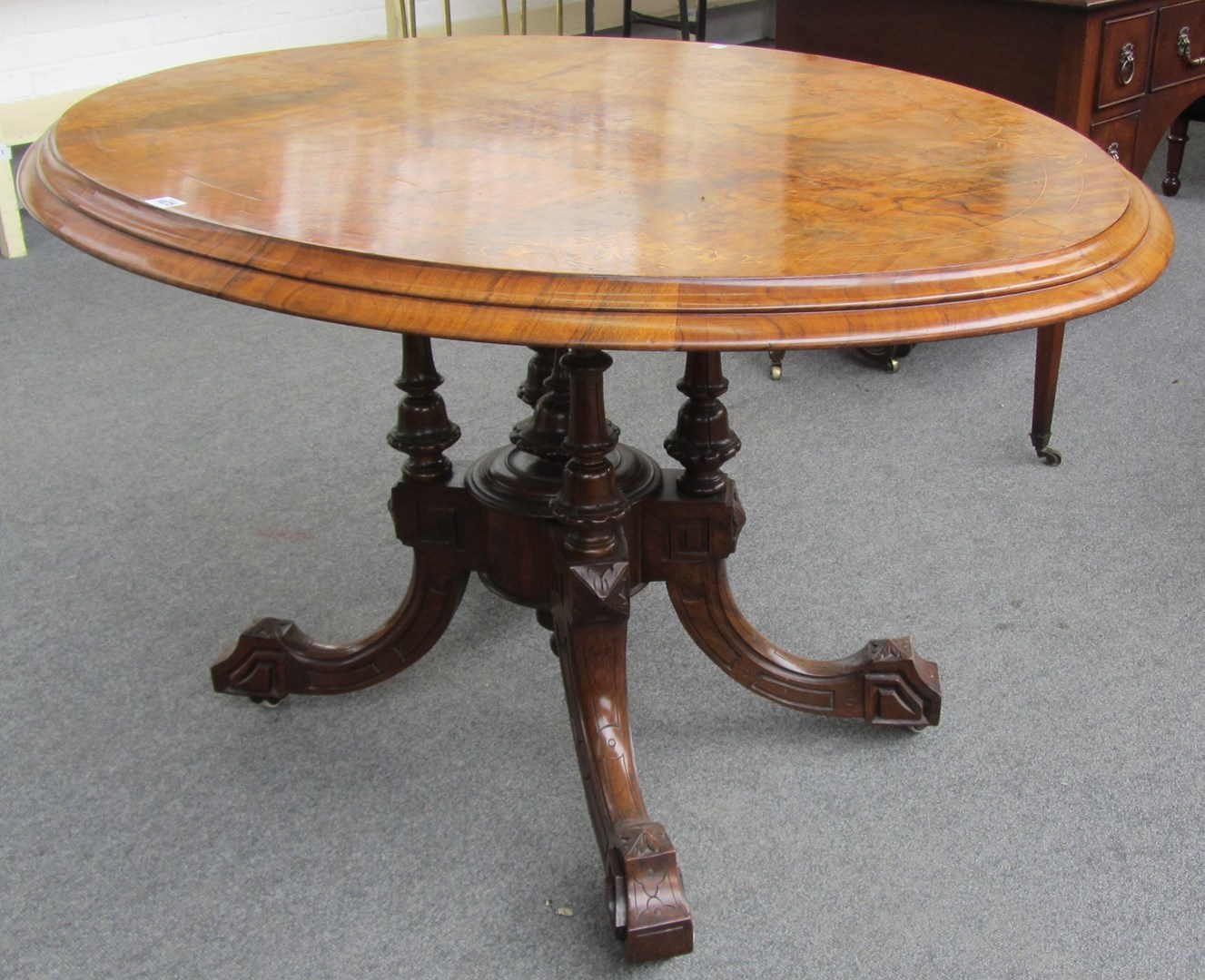 Appraisal: A Victorian oval marquetry inlaid walnut snap top centre table