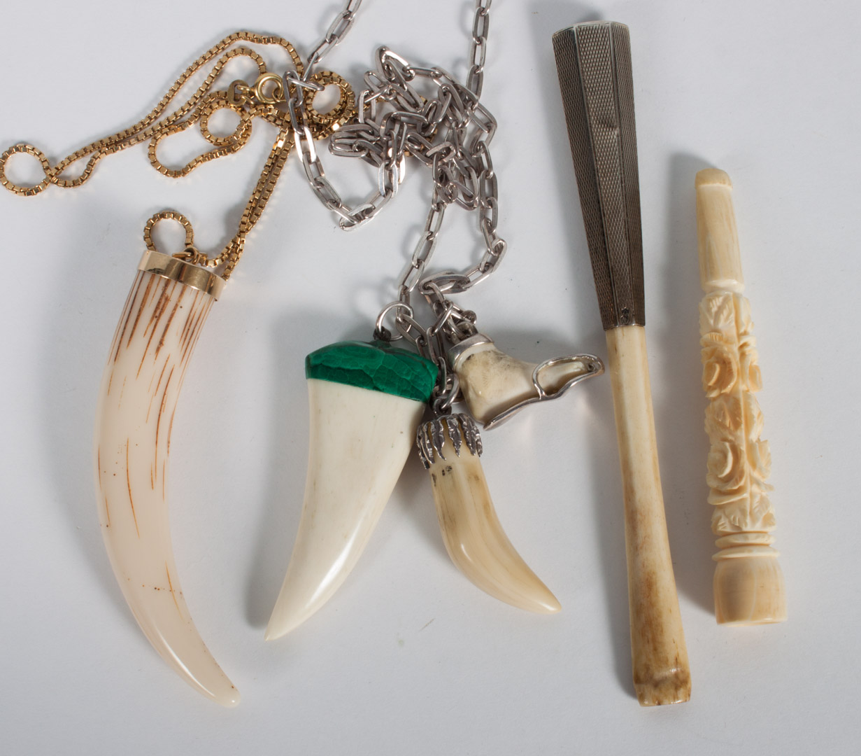 Appraisal: Four ivory or bone personal items or jewelry including an