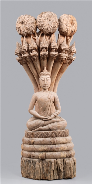 Appraisal: South Asian carved driftwood sitting lotus Buddha bellow a -headed