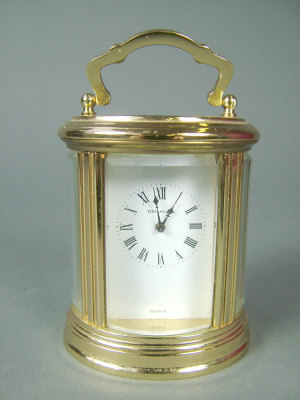 Appraisal: An oval gilt brass cased four glass miniature carriage clock