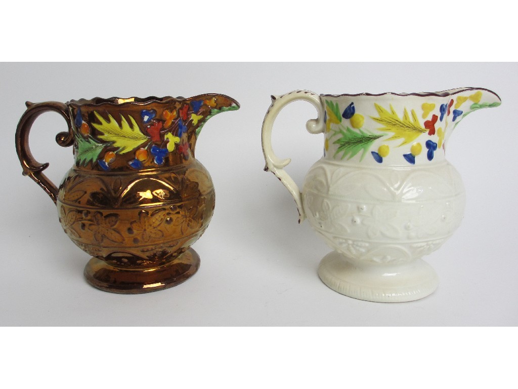 Appraisal: A copper lustre relief moulded jug decorated with flowers moulded